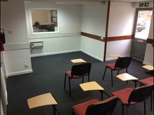 A room with chairs and tables
AI-generated content may be incorrect.